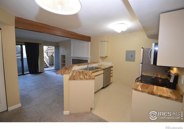 kitchen with white cabinets, dishwasher, kitchen peninsula, and sink