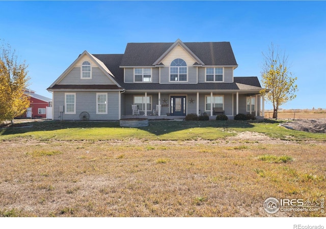 view of front facade with a front lawn and covered porch