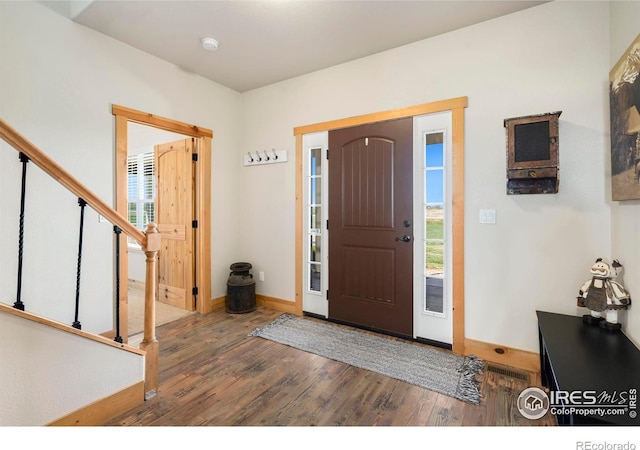 entrance foyer with dark hardwood / wood-style floors