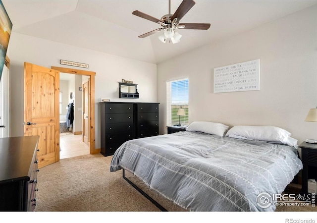 bedroom featuring lofted ceiling, light colored carpet, and ceiling fan