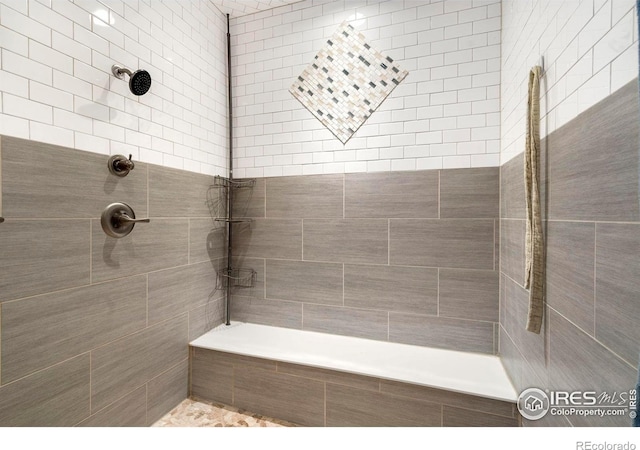 bathroom with a tile shower