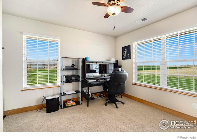 office area with ceiling fan, light colored carpet, and a healthy amount of sunlight