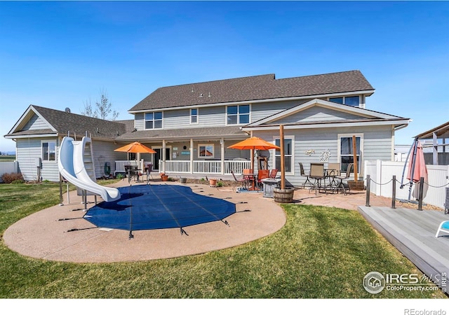 back of house featuring a yard and a patio