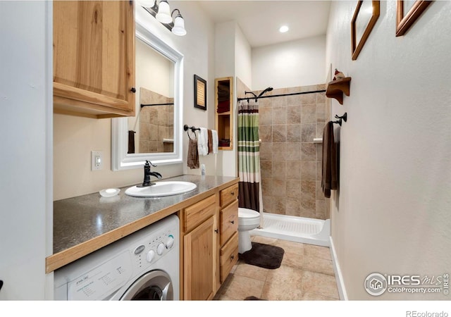 bathroom featuring a shower with curtain, vanity, washer / clothes dryer, and toilet