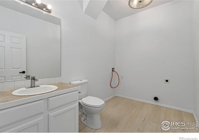 bathroom featuring hardwood / wood-style flooring, vanity, and toilet