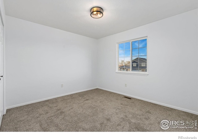 unfurnished room featuring carpet