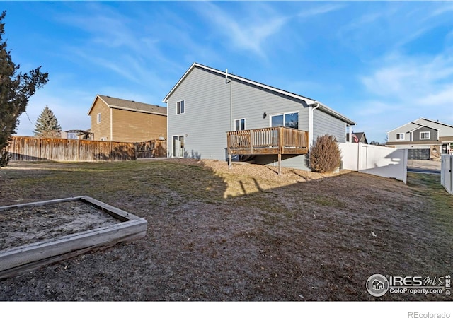 rear view of property featuring a wooden deck