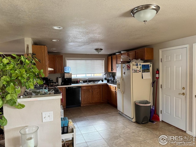 kitchen featuring white refrigerator with ice dispenser, dishwasher, brown cabinets, light countertops, and a sink