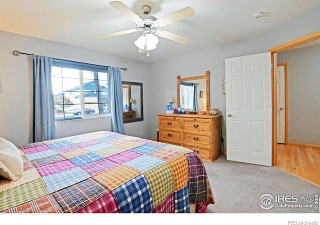 bedroom with ceiling fan and light colored carpet