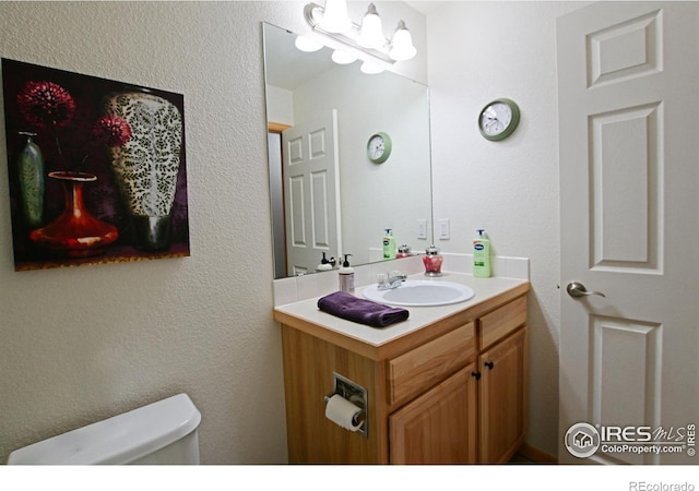 bathroom with vanity and toilet