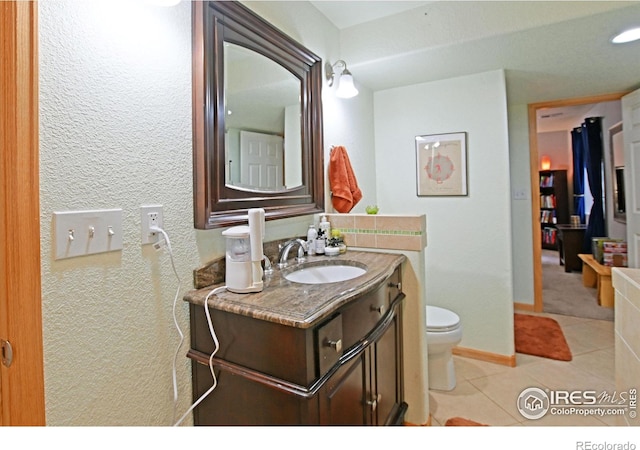 bathroom with tile patterned floors, vanity, and toilet