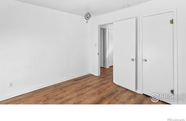 unfurnished bedroom featuring dark hardwood / wood-style floors