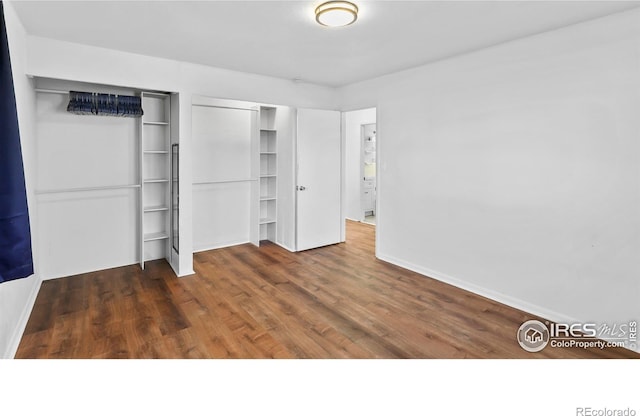 unfurnished bedroom featuring dark hardwood / wood-style flooring