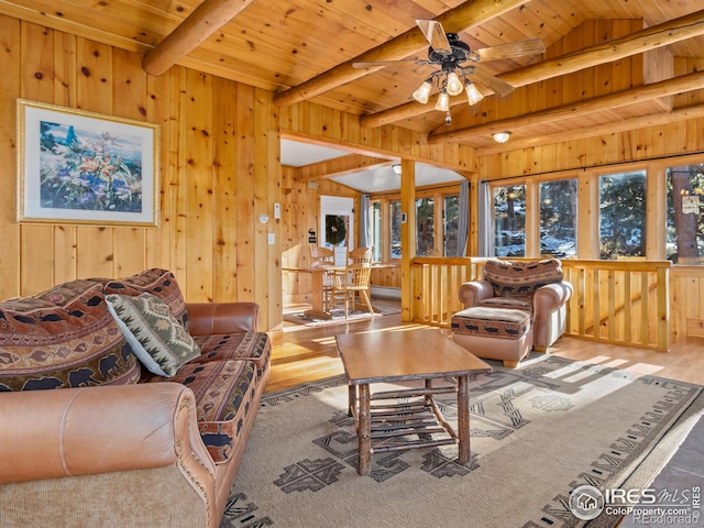 living room with wooden walls, light hardwood / wood-style flooring, and wooden ceiling