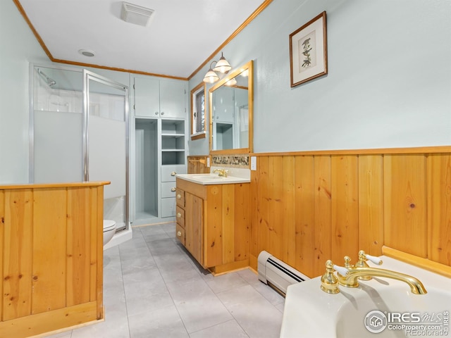 bathroom featuring tile patterned flooring, vanity, a shower with shower door, and ornamental molding