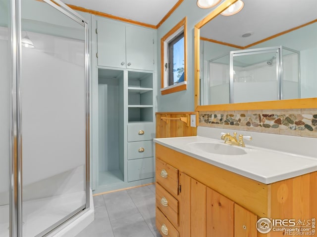 bathroom with decorative backsplash, tile patterned flooring, vanity, and an enclosed shower