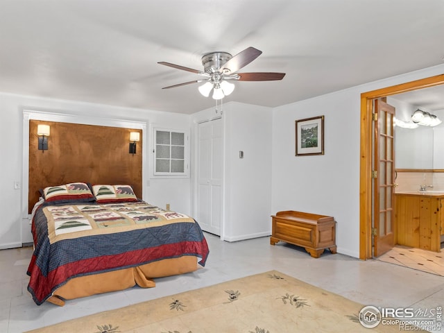 bedroom with a closet, ensuite bathroom, ceiling fan, and sink