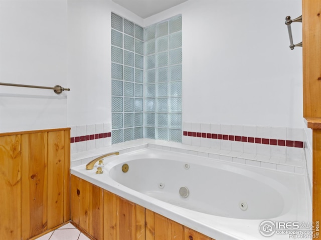 bathroom featuring tile patterned flooring and a tub to relax in