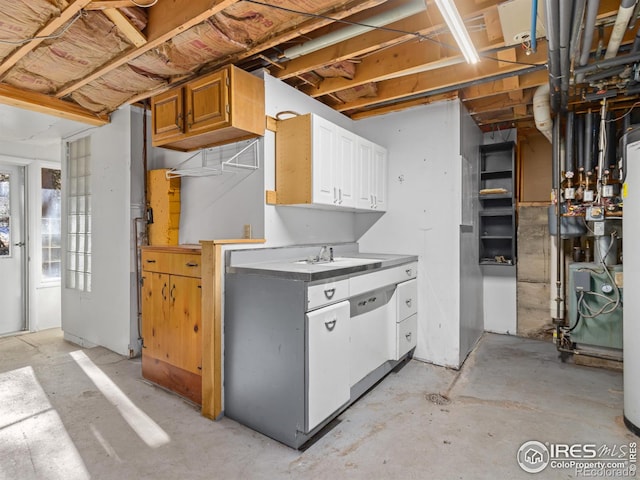 kitchen with white cabinets, white dishwasher, and sink