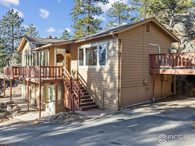 view of front of house with a wooden deck and a garage