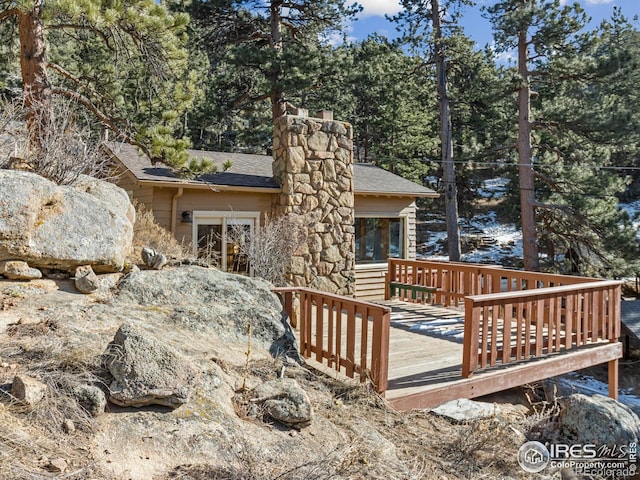 back of property with a wooden deck