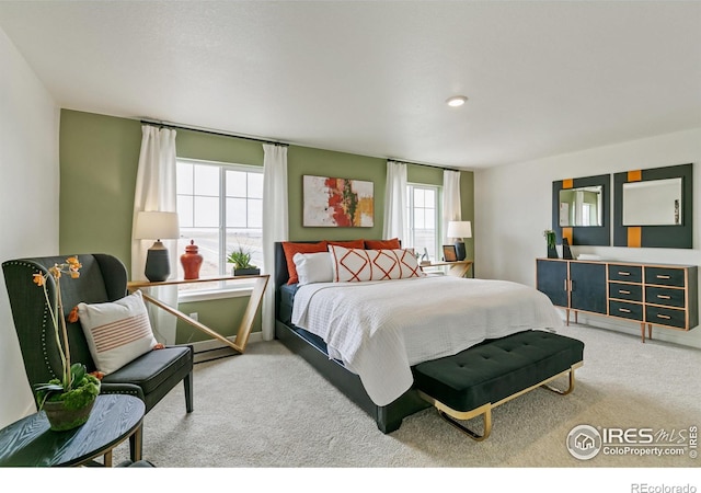 bedroom featuring carpet and multiple windows