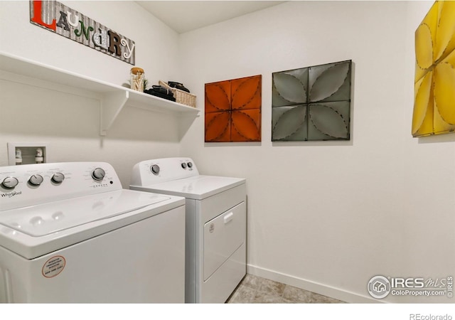 laundry room with washer and clothes dryer and light tile patterned flooring