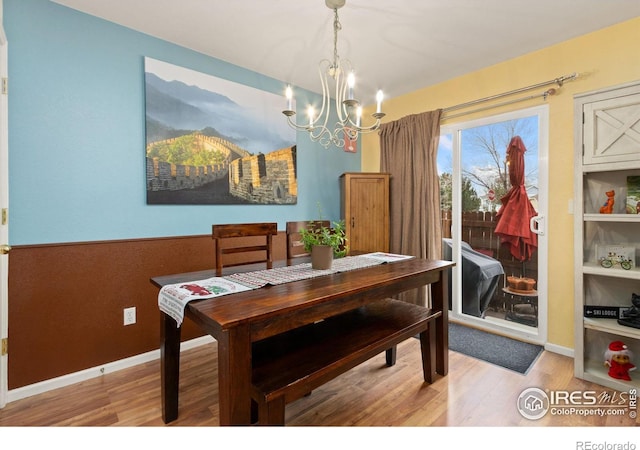 dining space featuring a notable chandelier and wood-type flooring