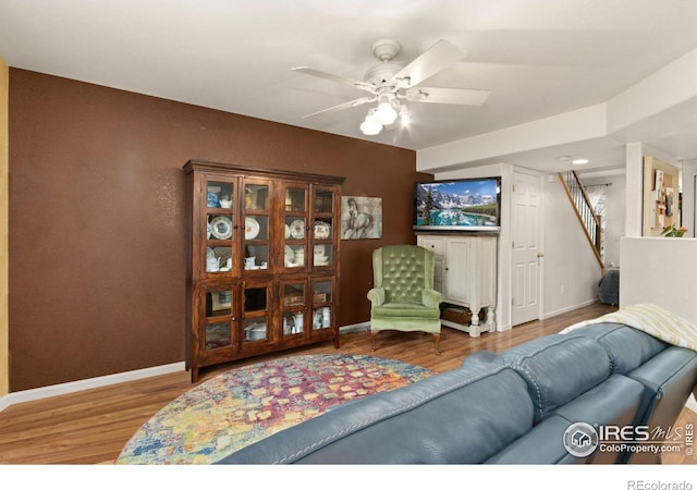 living room with ceiling fan and wood-type flooring