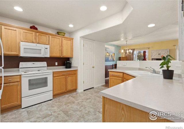 kitchen with hanging light fixtures, a chandelier, white appliances, and sink