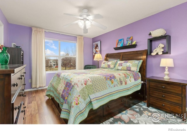 bedroom with light hardwood / wood-style floors and ceiling fan