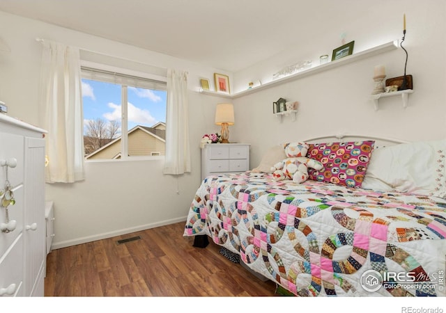 bedroom featuring dark hardwood / wood-style flooring