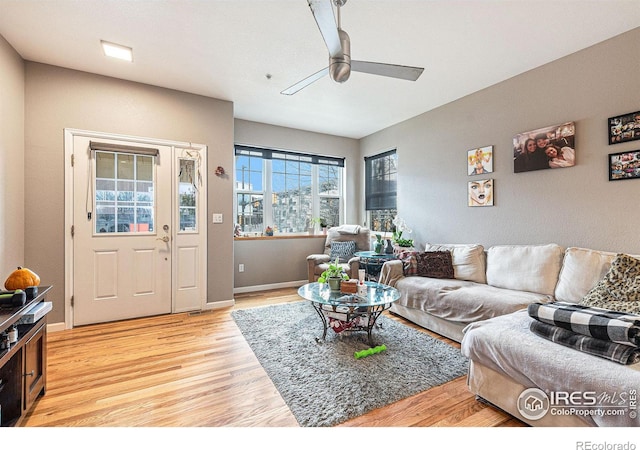 living room featuring hardwood / wood-style floors and ceiling fan