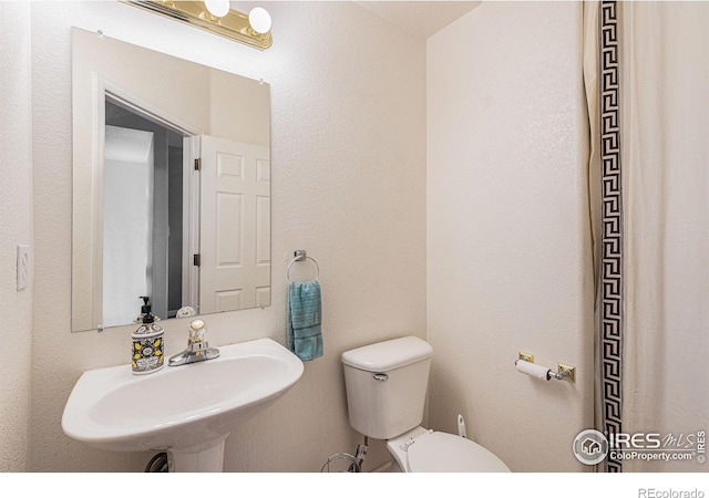 bathroom with toilet and sink