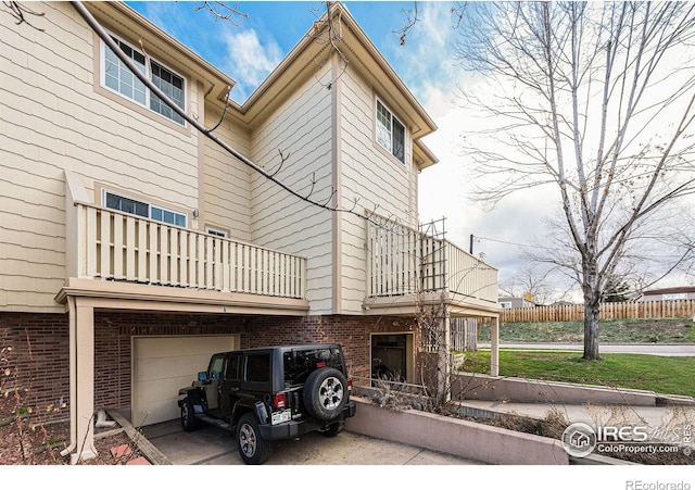 view of side of home with a balcony and a garage