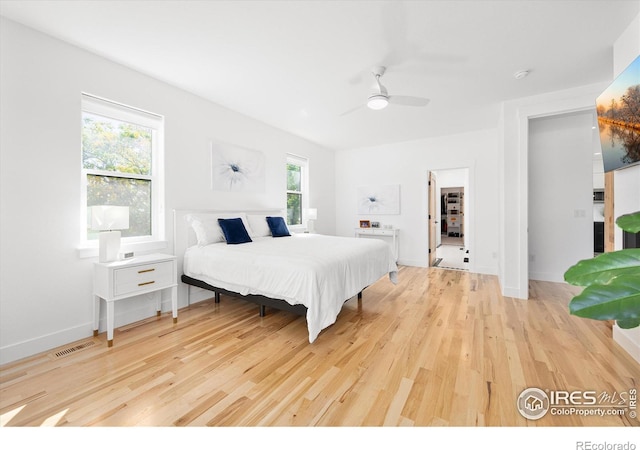 bedroom featuring multiple windows, ceiling fan, and light hardwood / wood-style floors