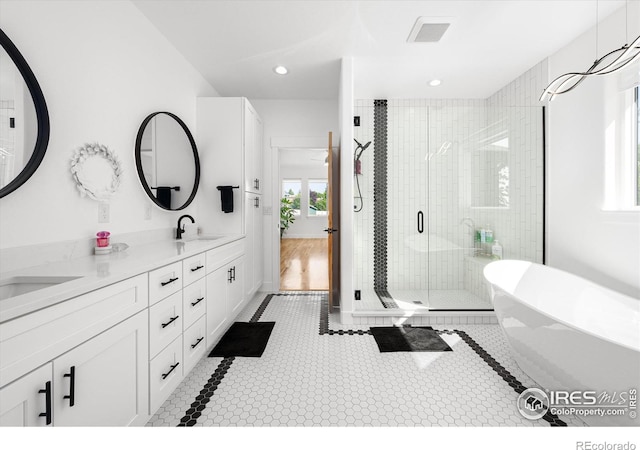 bathroom with vanity and separate shower and tub