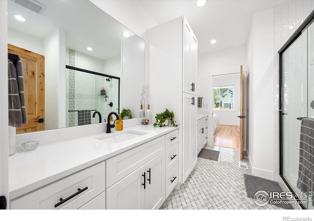 bathroom featuring tile patterned floors, vanity, and walk in shower