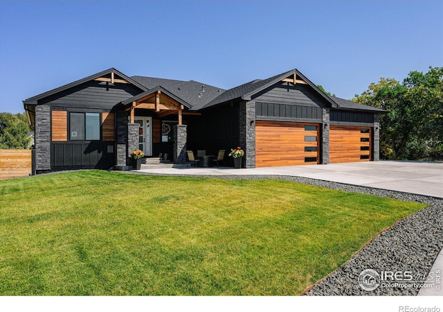 view of front of house with a garage and a front lawn