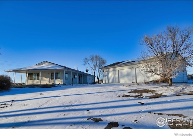 view of front of property featuring a garage and covered porch