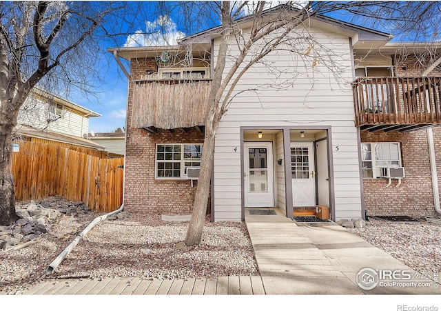 view of front of home with a balcony and cooling unit