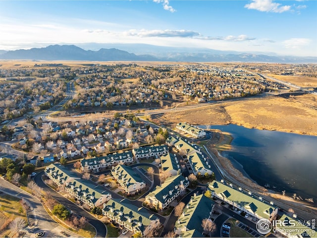 drone / aerial view with a water and mountain view