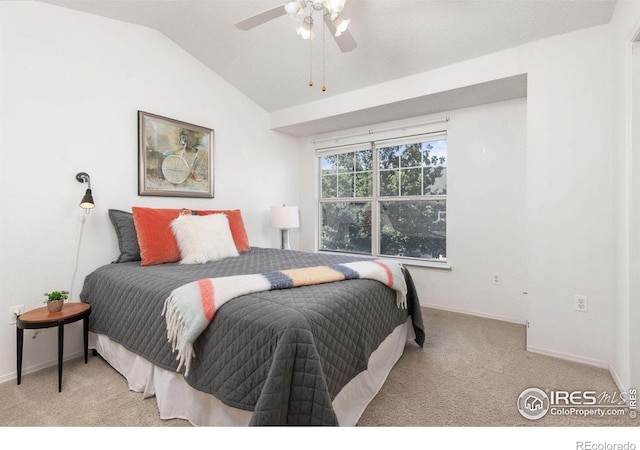 bedroom with ceiling fan, light carpet, and vaulted ceiling