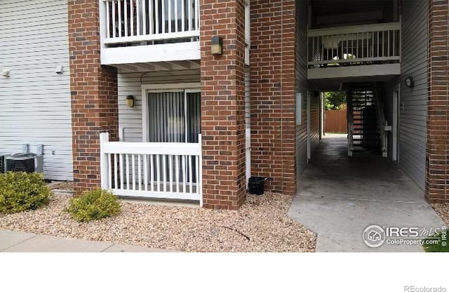 property entrance featuring central AC unit