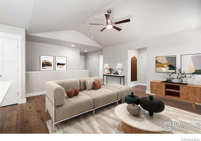 living room with a ceiling fan, vaulted ceiling, baseboards, and wood finished floors