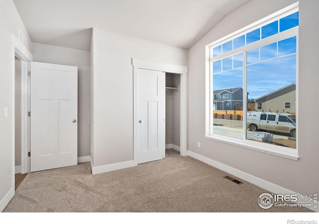 unfurnished bedroom with carpet, visible vents, and baseboards