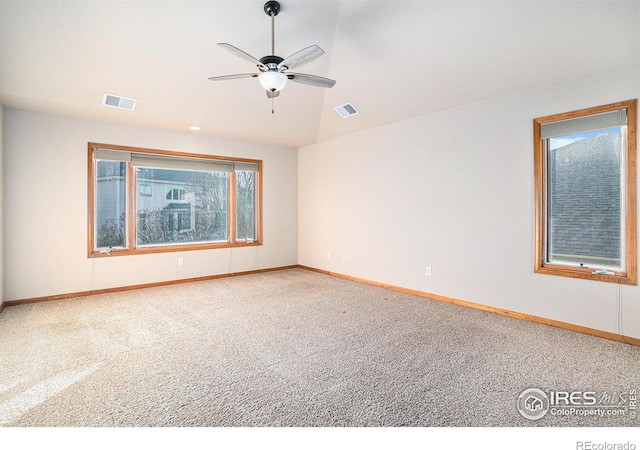 carpeted empty room featuring ceiling fan and vaulted ceiling