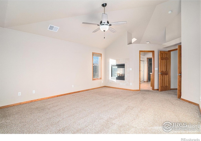 unfurnished living room featuring high vaulted ceiling, ceiling fan, light carpet, and a tile fireplace