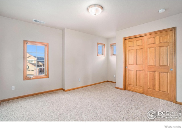 unfurnished bedroom with carpet and a closet