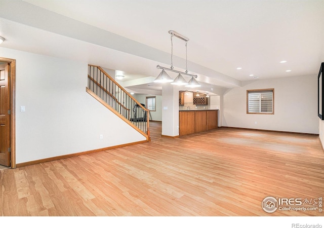 unfurnished living room with light wood-type flooring